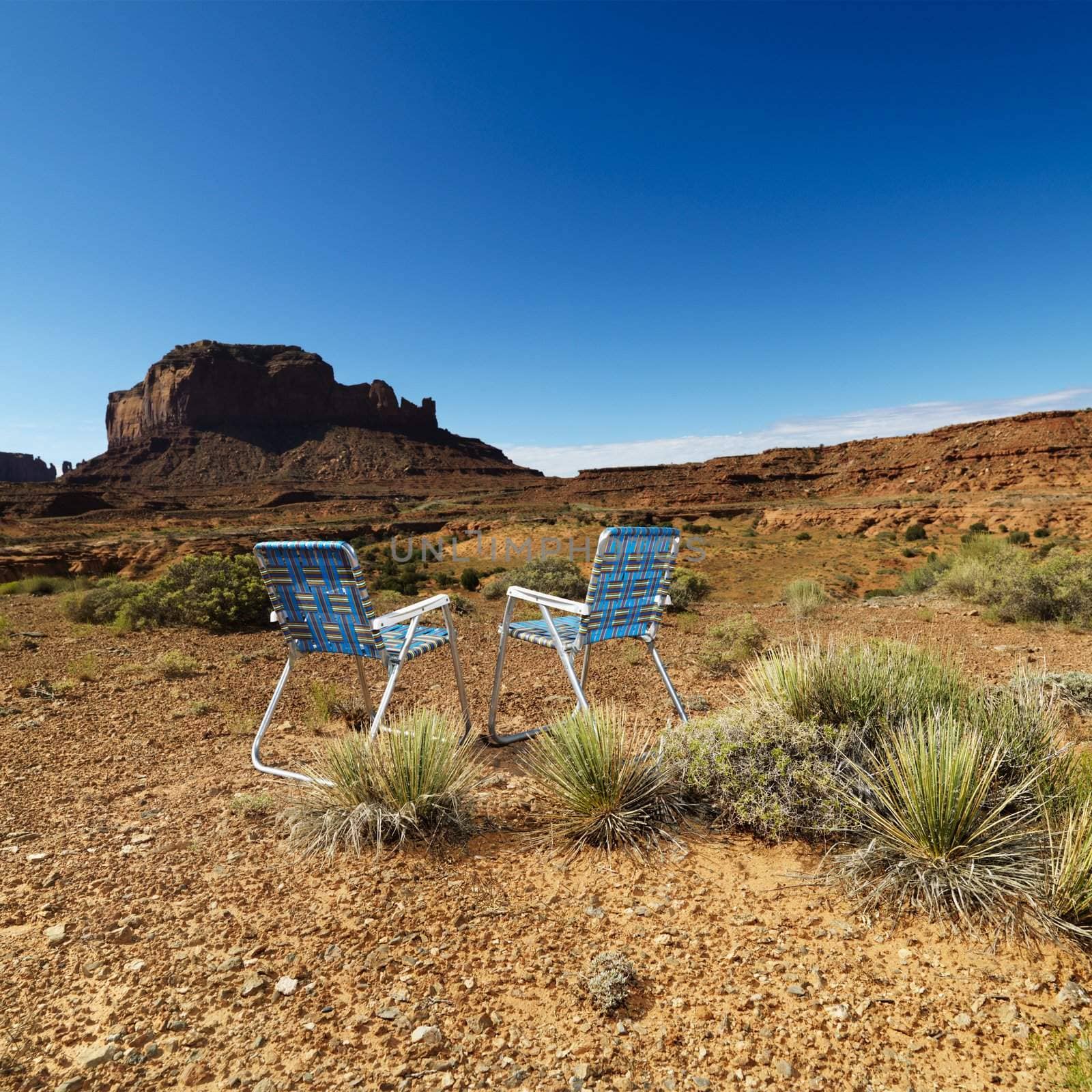 Chairs in desert. by iofoto