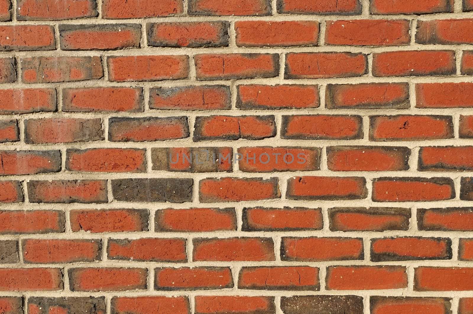 Bright and colorful brick wall with cracks - background texture