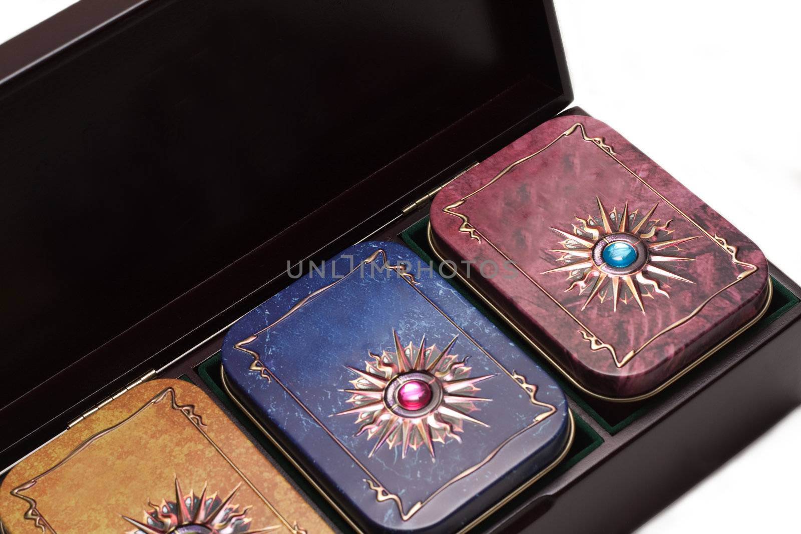 Box with tea, iron packing, decorated stone on white background