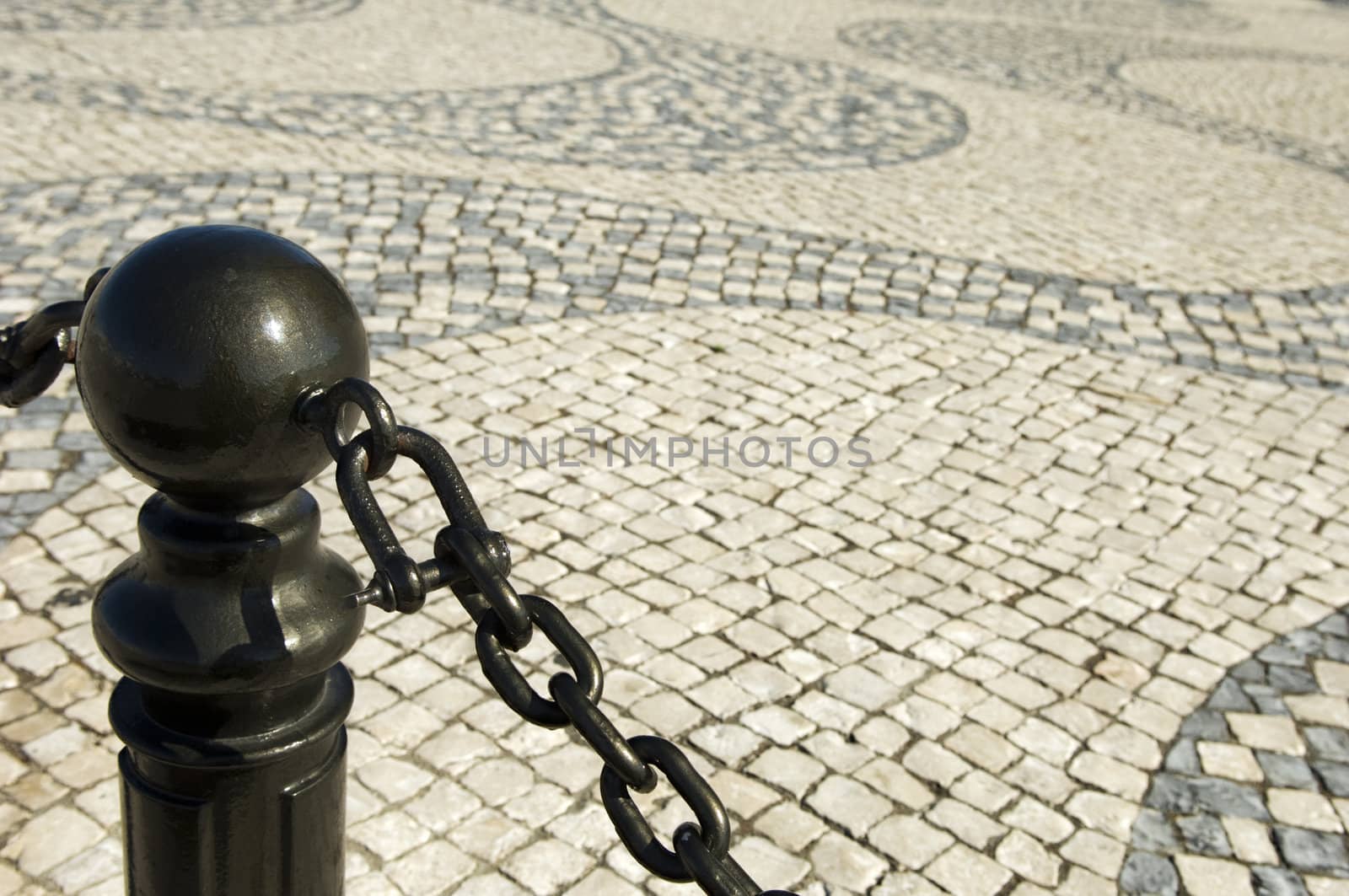 Street bollard in the side walk against a causeway background