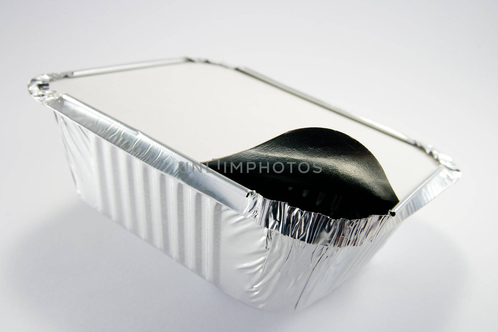 Square silver foil tray with lid slightly open on a white background