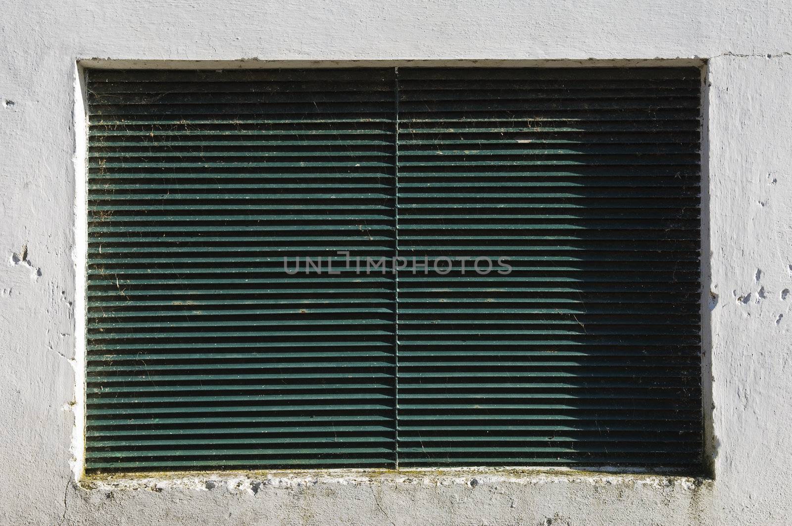 Detail of white wall with a ventilation grate