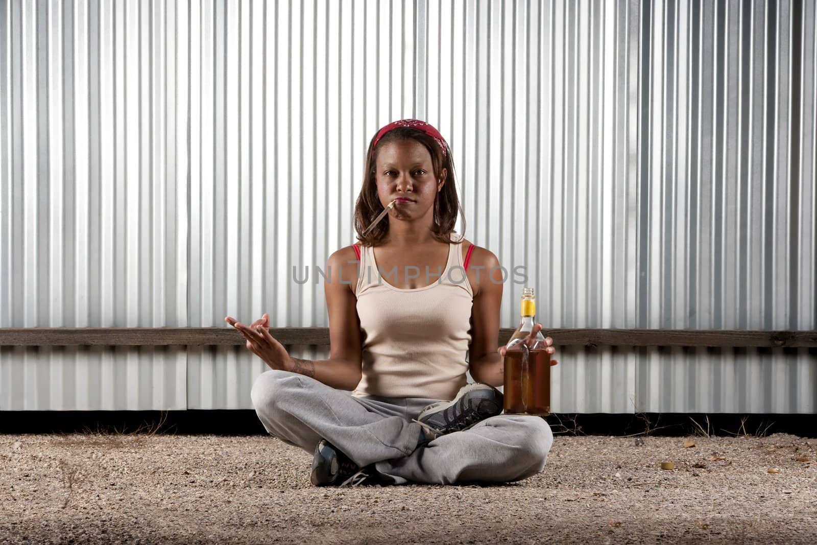 Woman meditating with cigar and tequila bottle