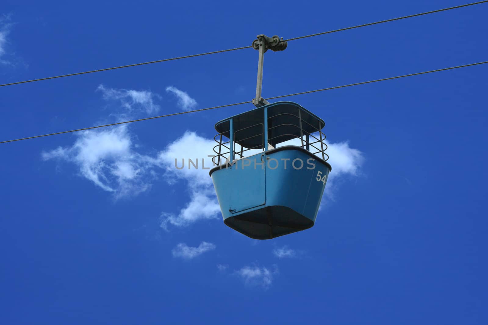 A Gondola lift car against blue sky