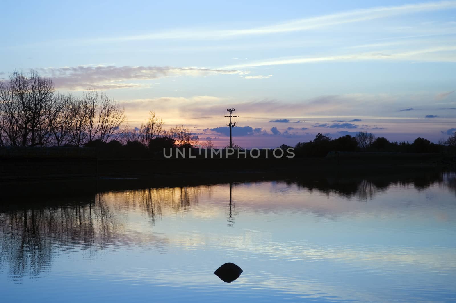 Lake at sunset with a beautiful smooth water surface 