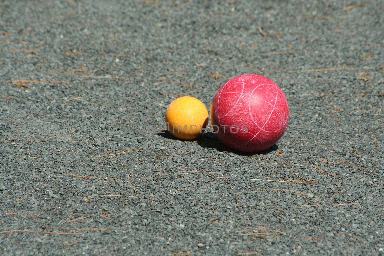 A Red bocce ball near the pallino