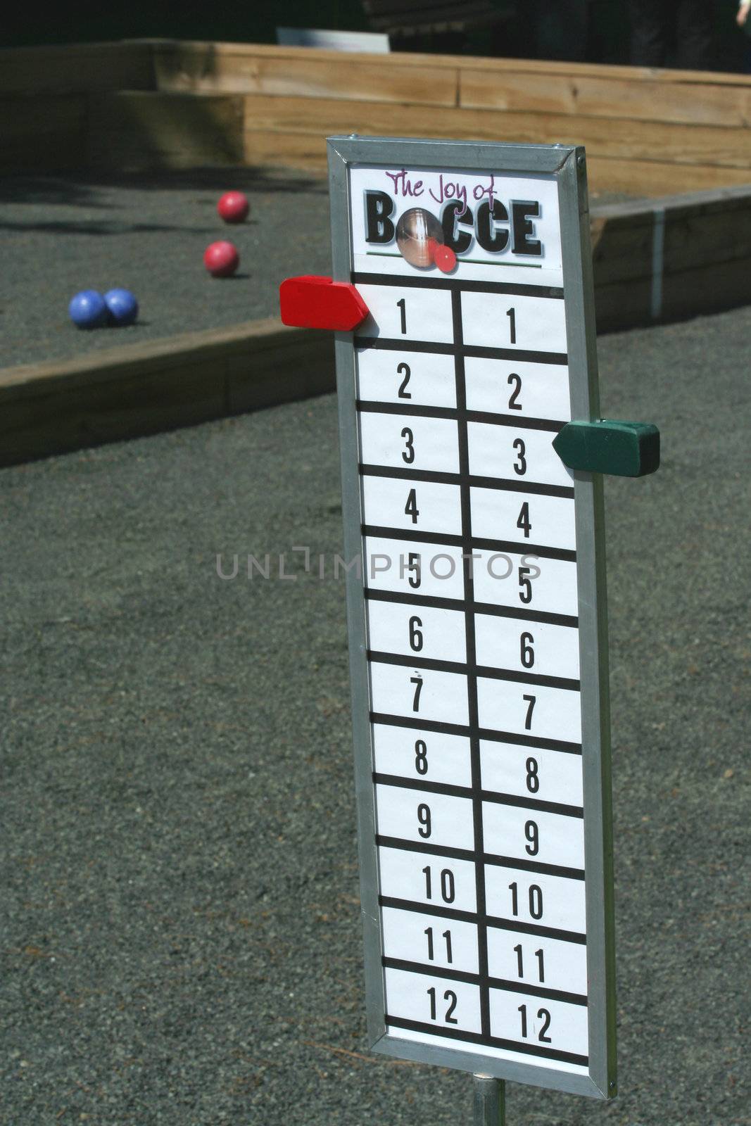 A Bocce ball score board on a court