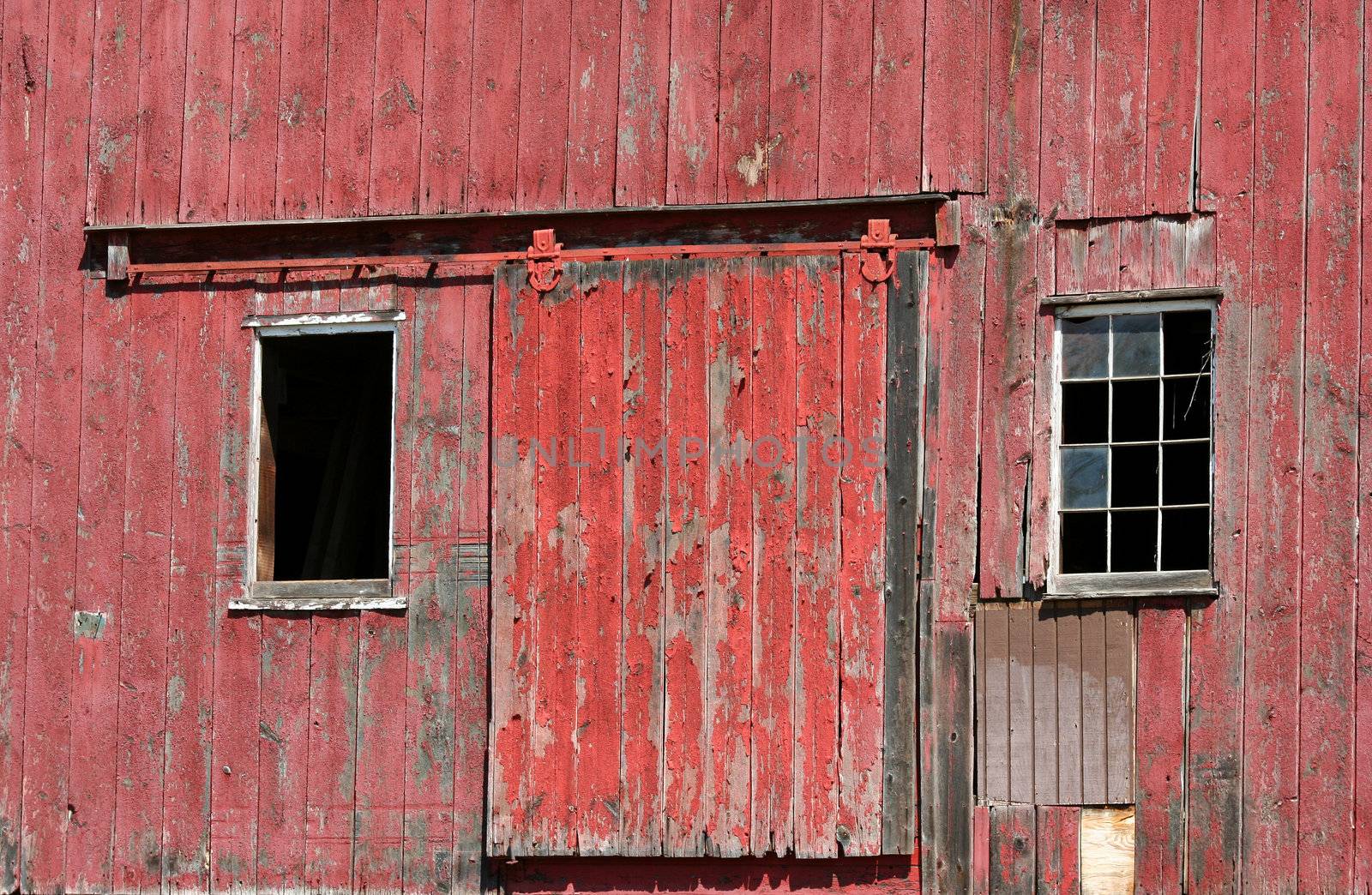A Old red barn door with windows