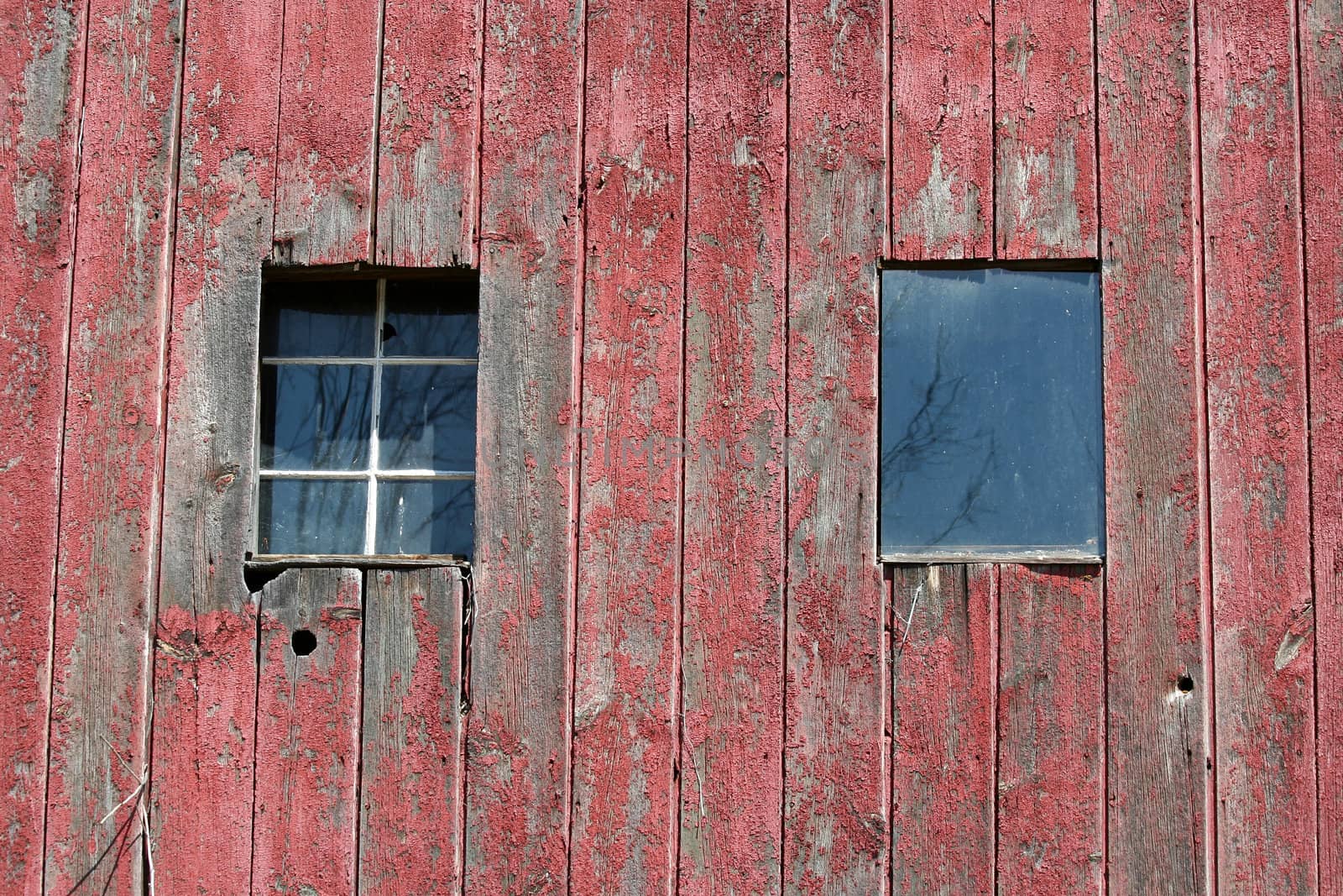 Two window on the side of a old barn image