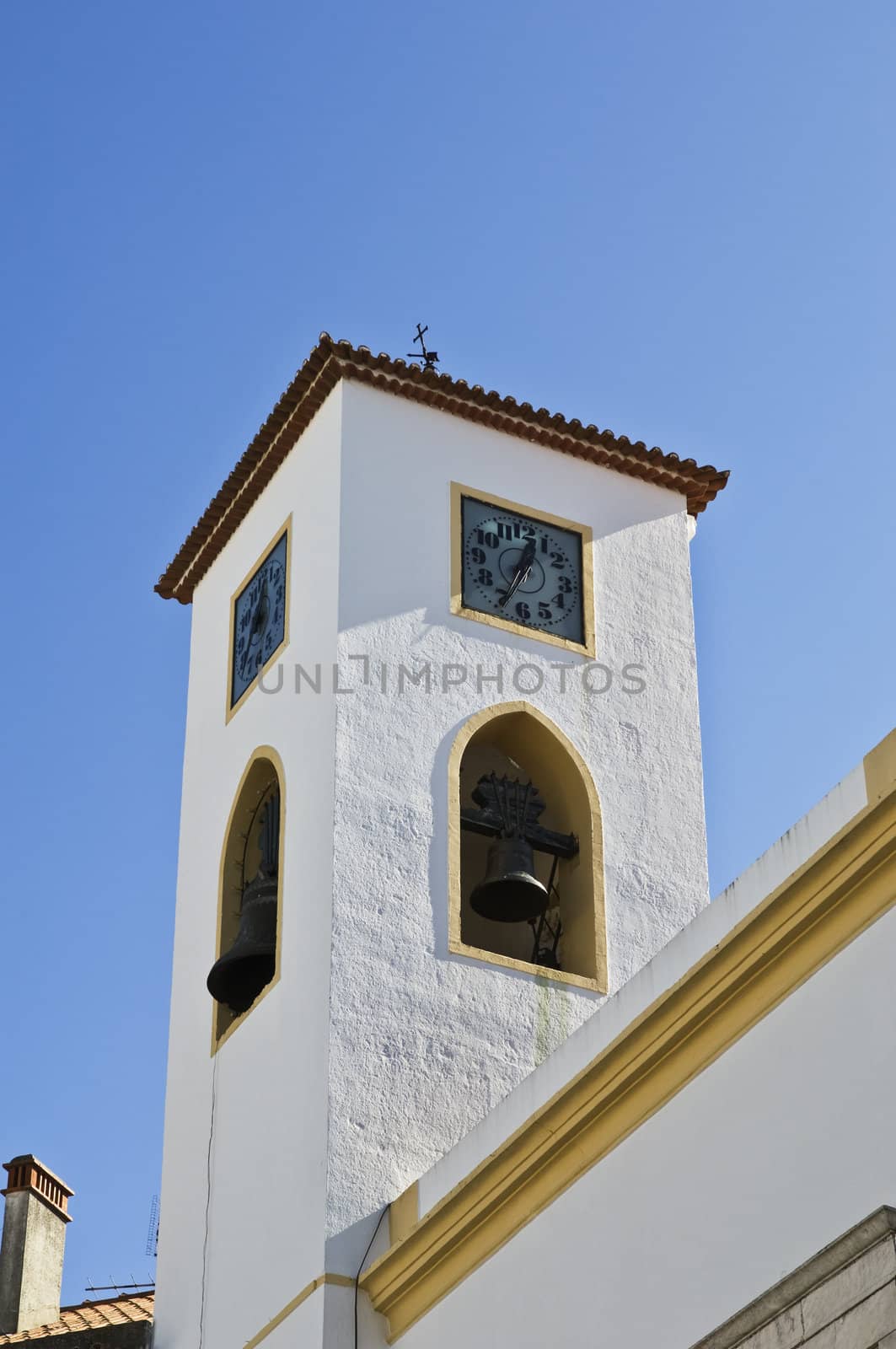 Traditional portuguese clock and bell tower in clear sky
