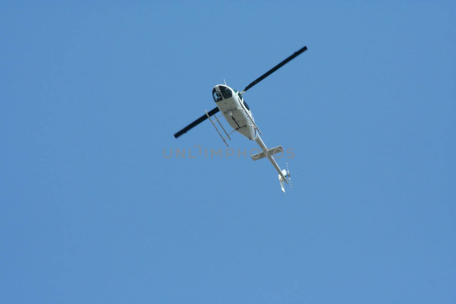 A Isolated helicopter against a blue sky