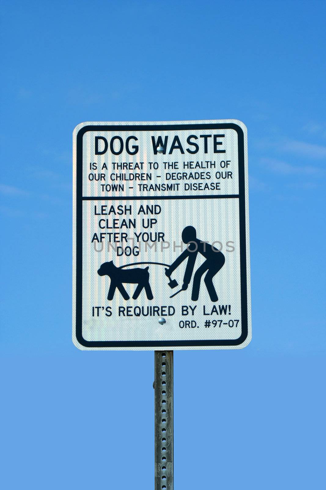 A dog waste sing against a blue sky