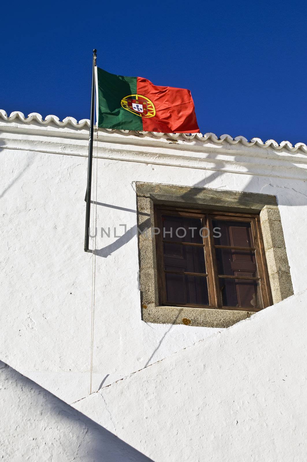 Portuguese flag hoisted in the former Court House of the medieval village of Monsaraz, Alentejo, Portugal