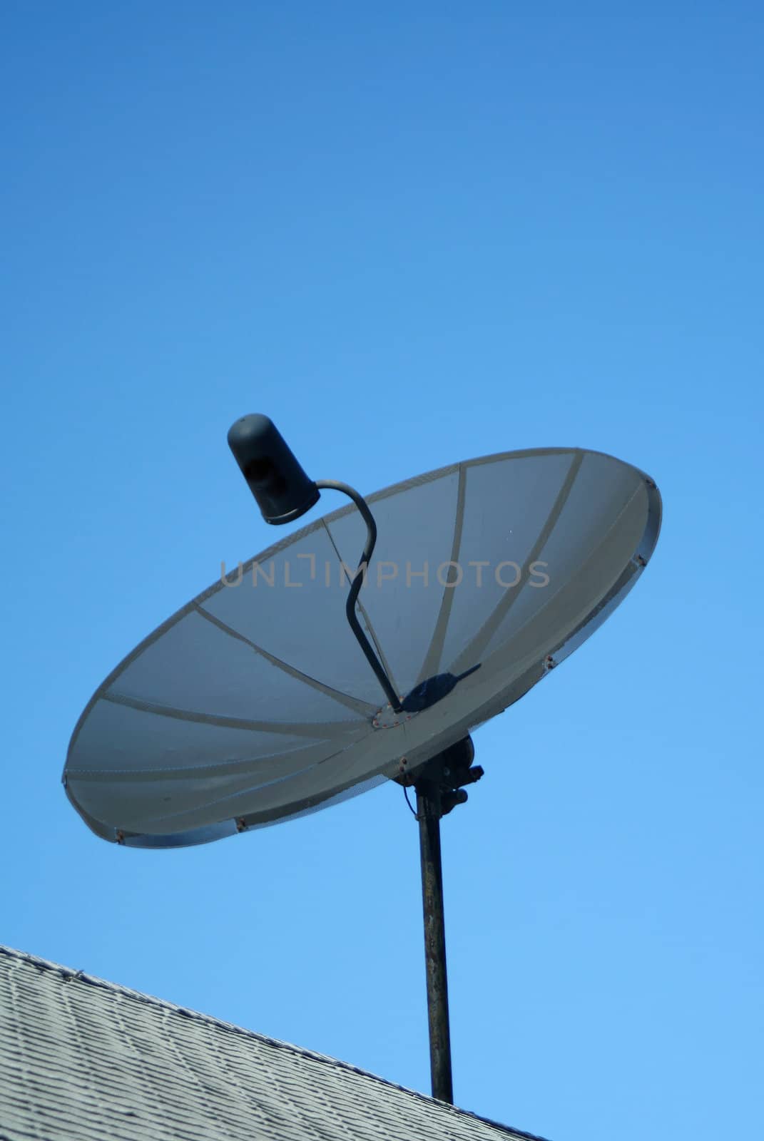 A Black satellite dish against a blue sky