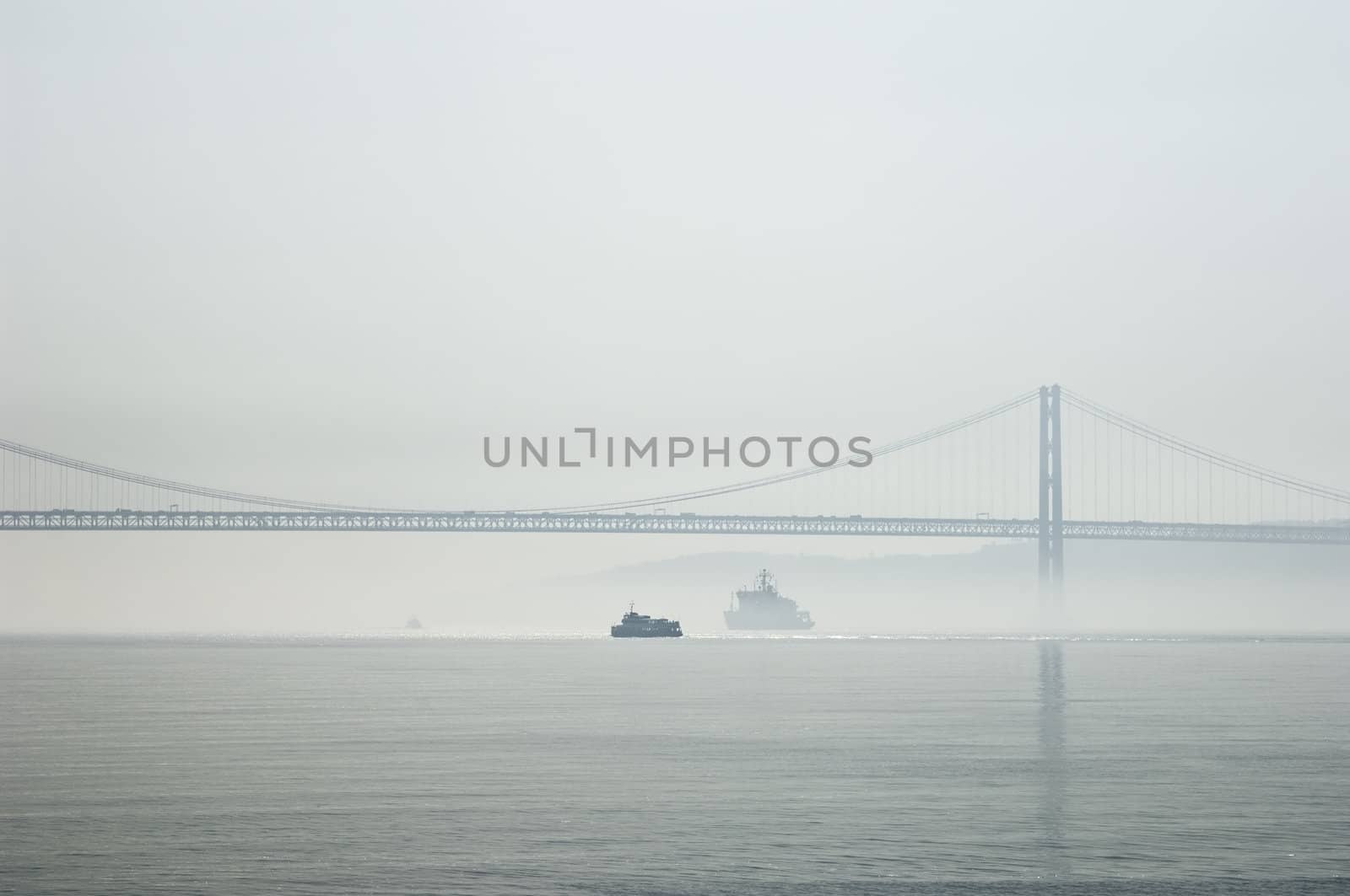 Ferrys crossing the Tagus river in a foggy morning by mrfotos