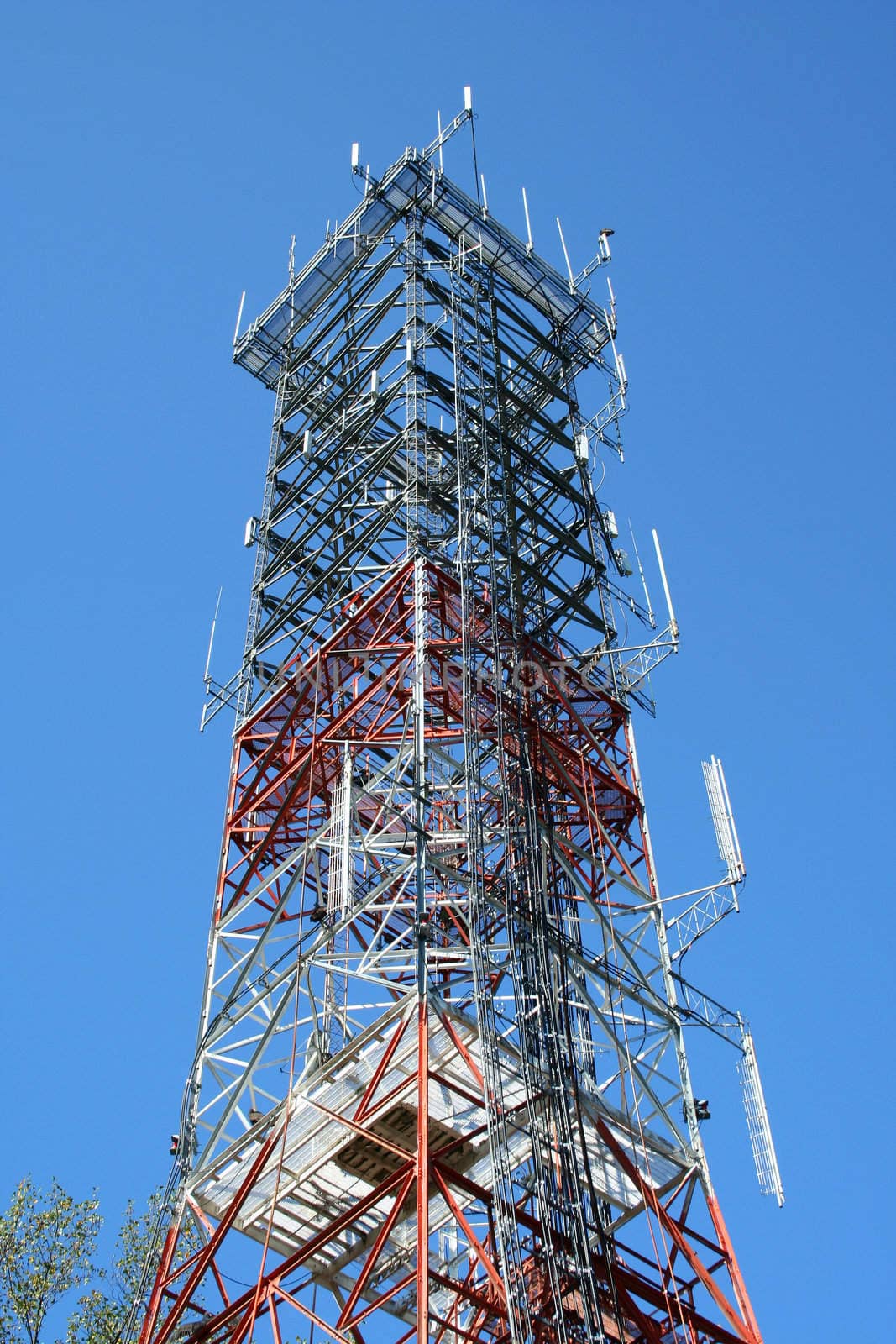A Radio antenna tower against a blue sky