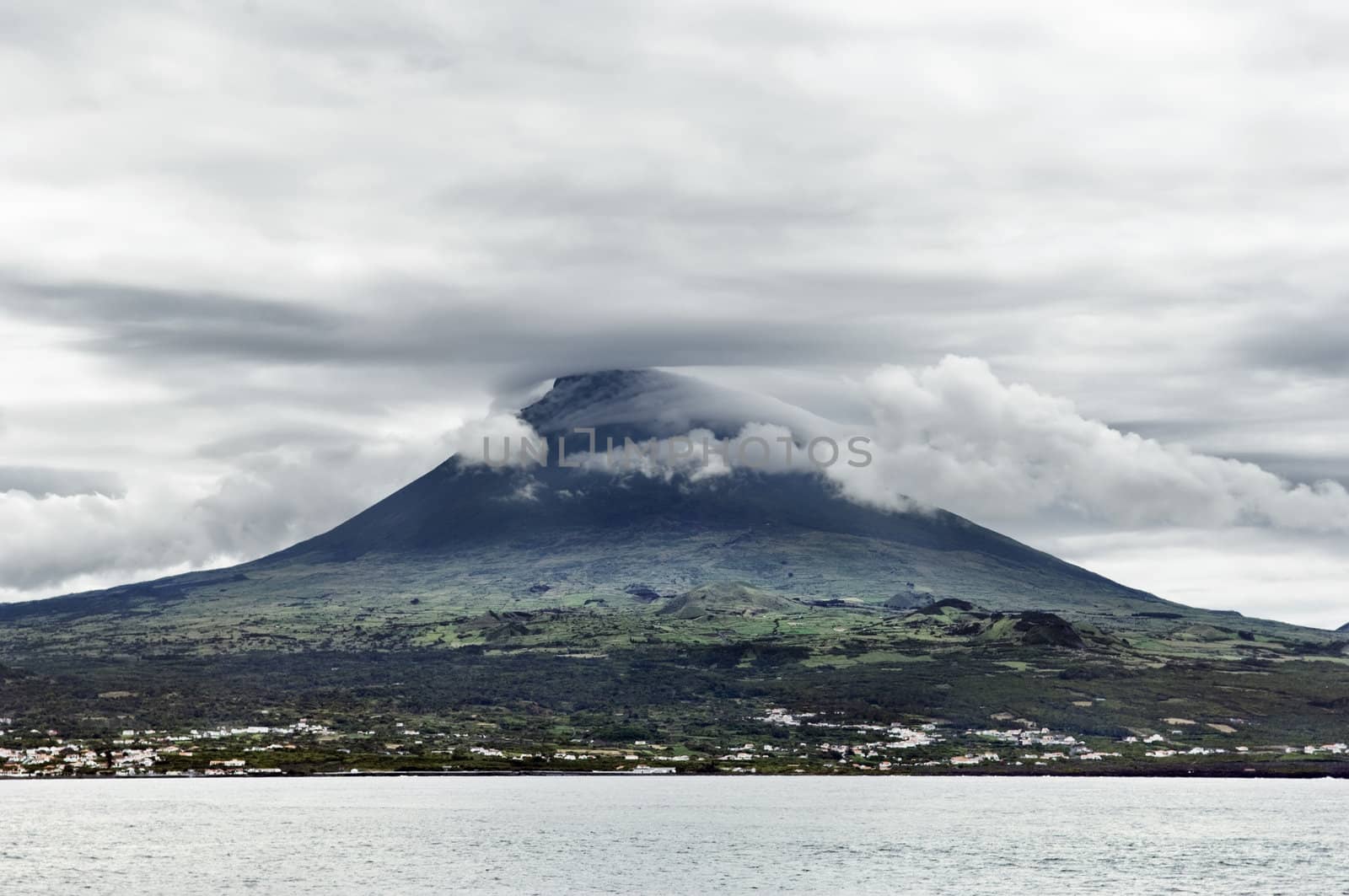 Overcast sky over Pico volcanic mountain view from the sea, Pico island, Azores, Portugal
