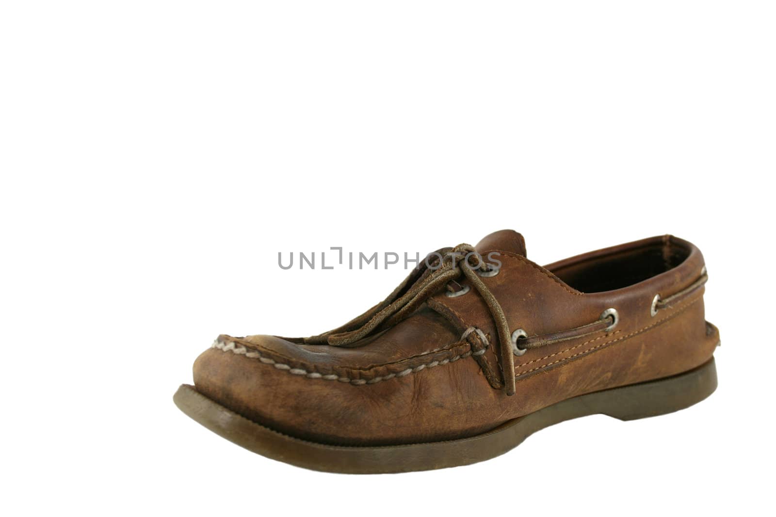An Old worn mens deck shoe isolated on white