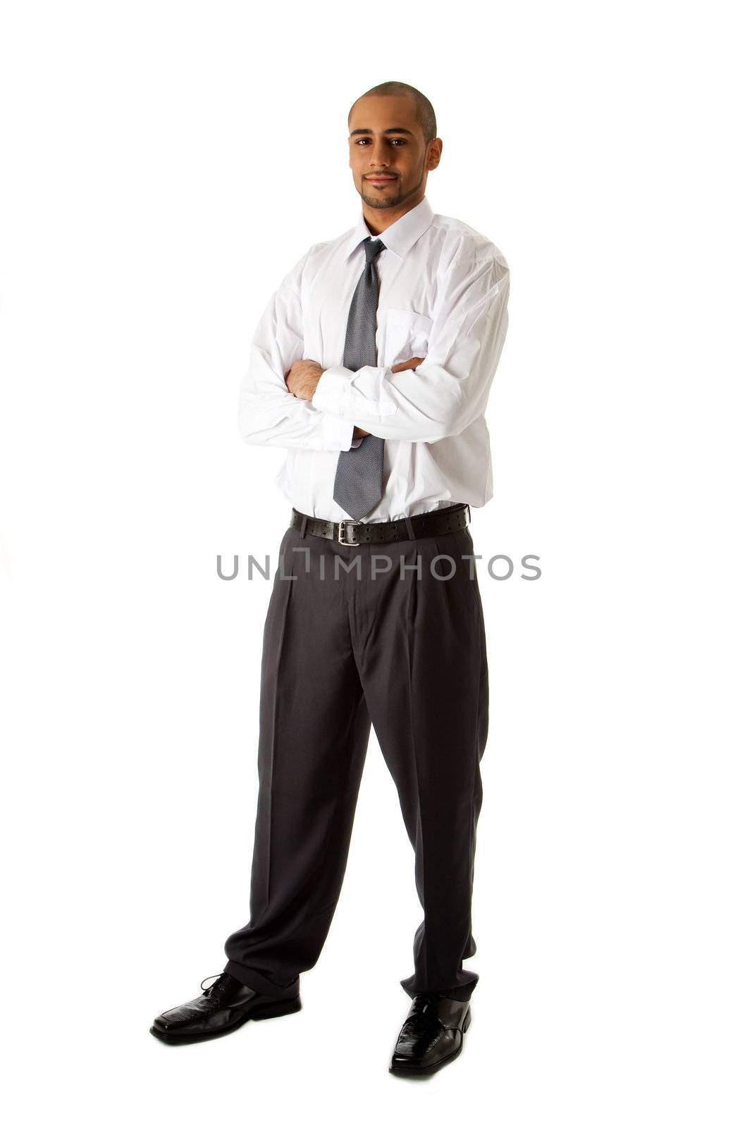 Handsome African Hispanic business man in white shirt, gray pants and tie, standing with arms crossed, isolated