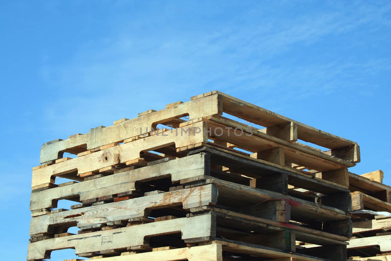 Stacked Pallets against a blue sky