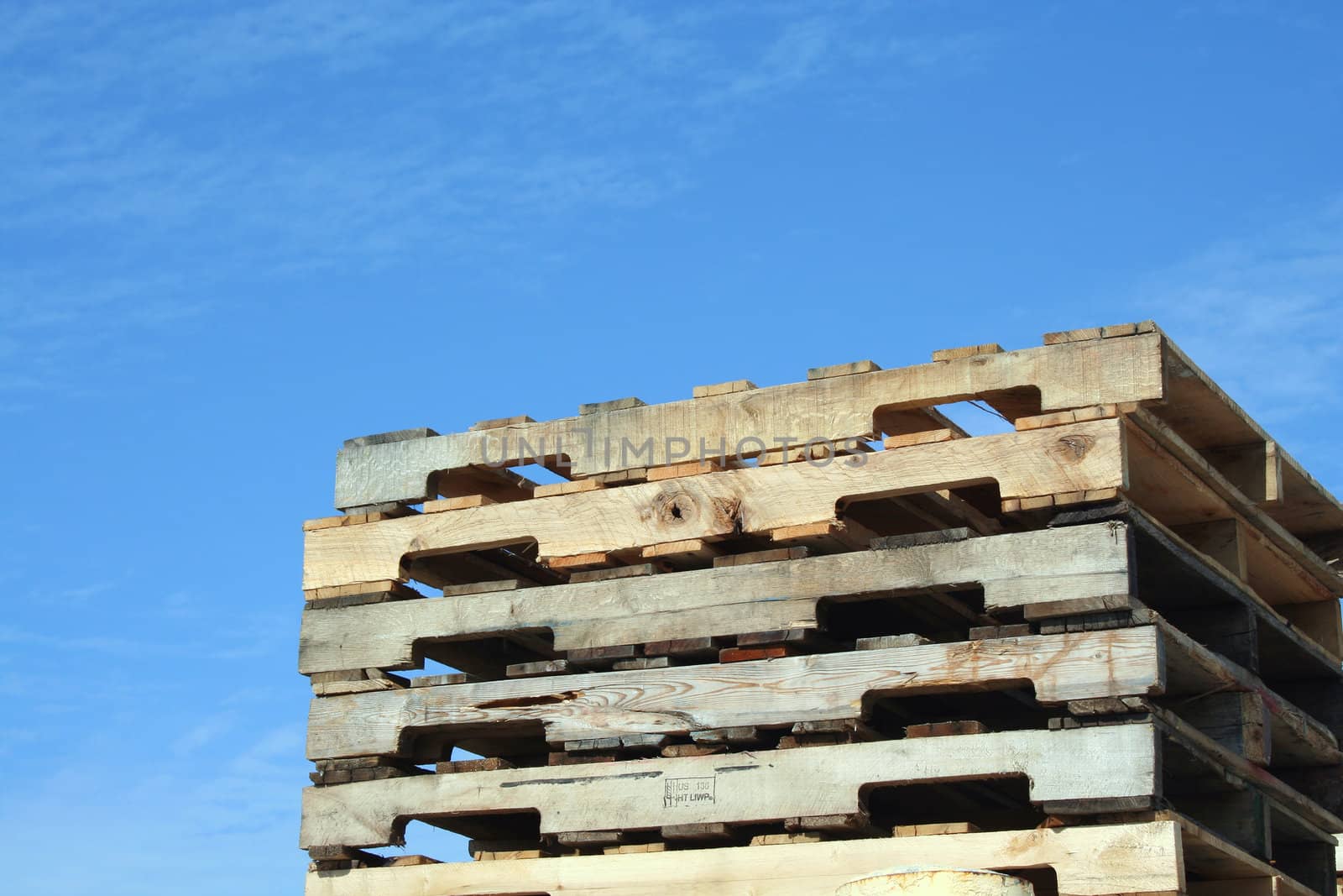 Stacked Pallets against a blue sky