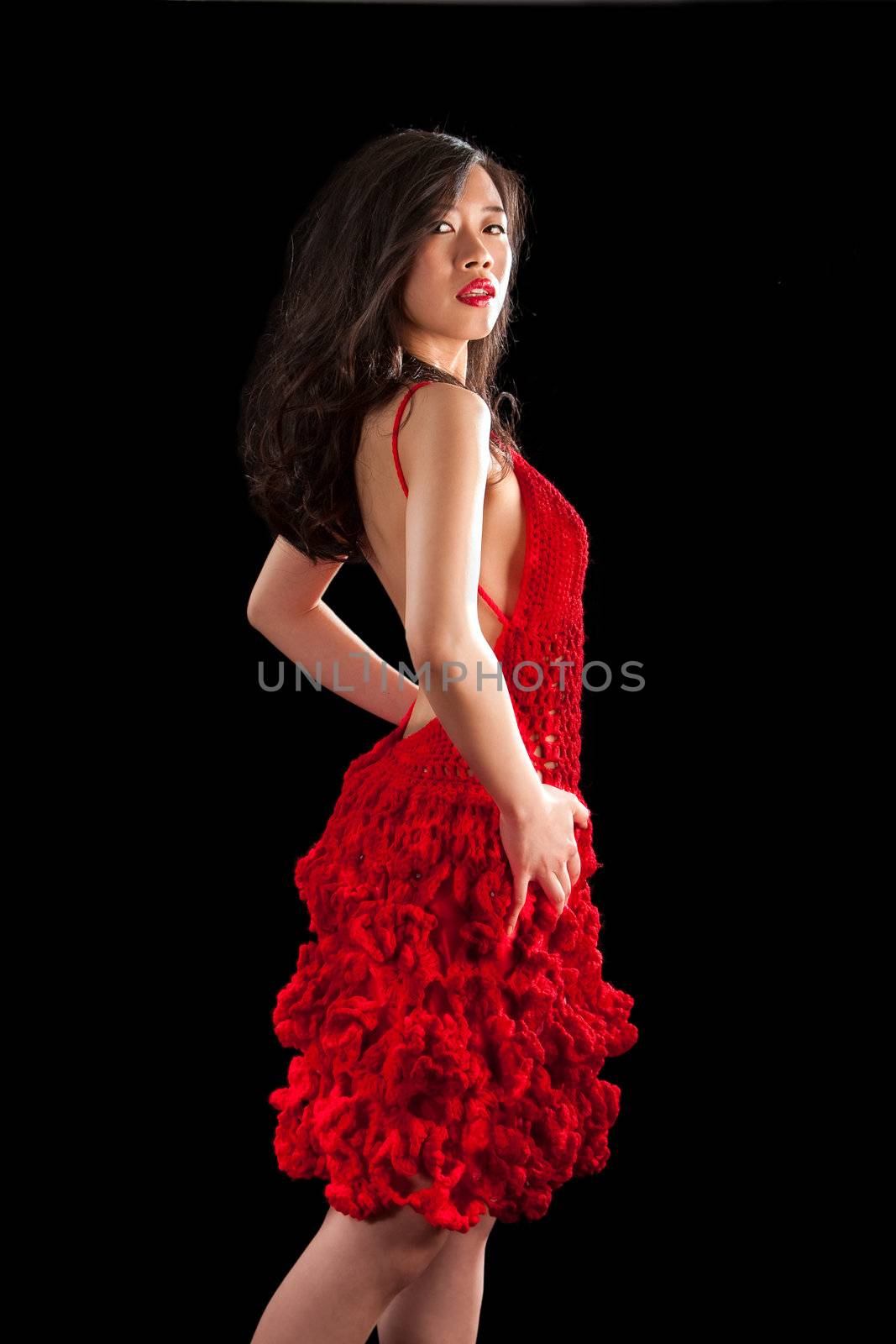 Beautiful sexy Asian woman in a crochet red dress, isolated
