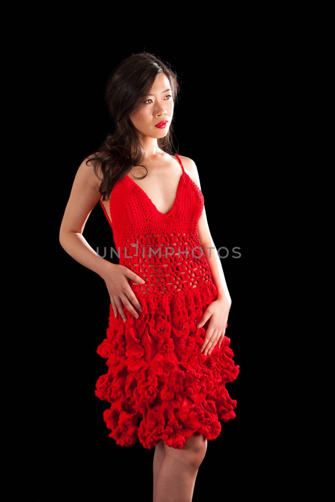 Beautiful sexy Asian woman in a crochet red dress, isolated