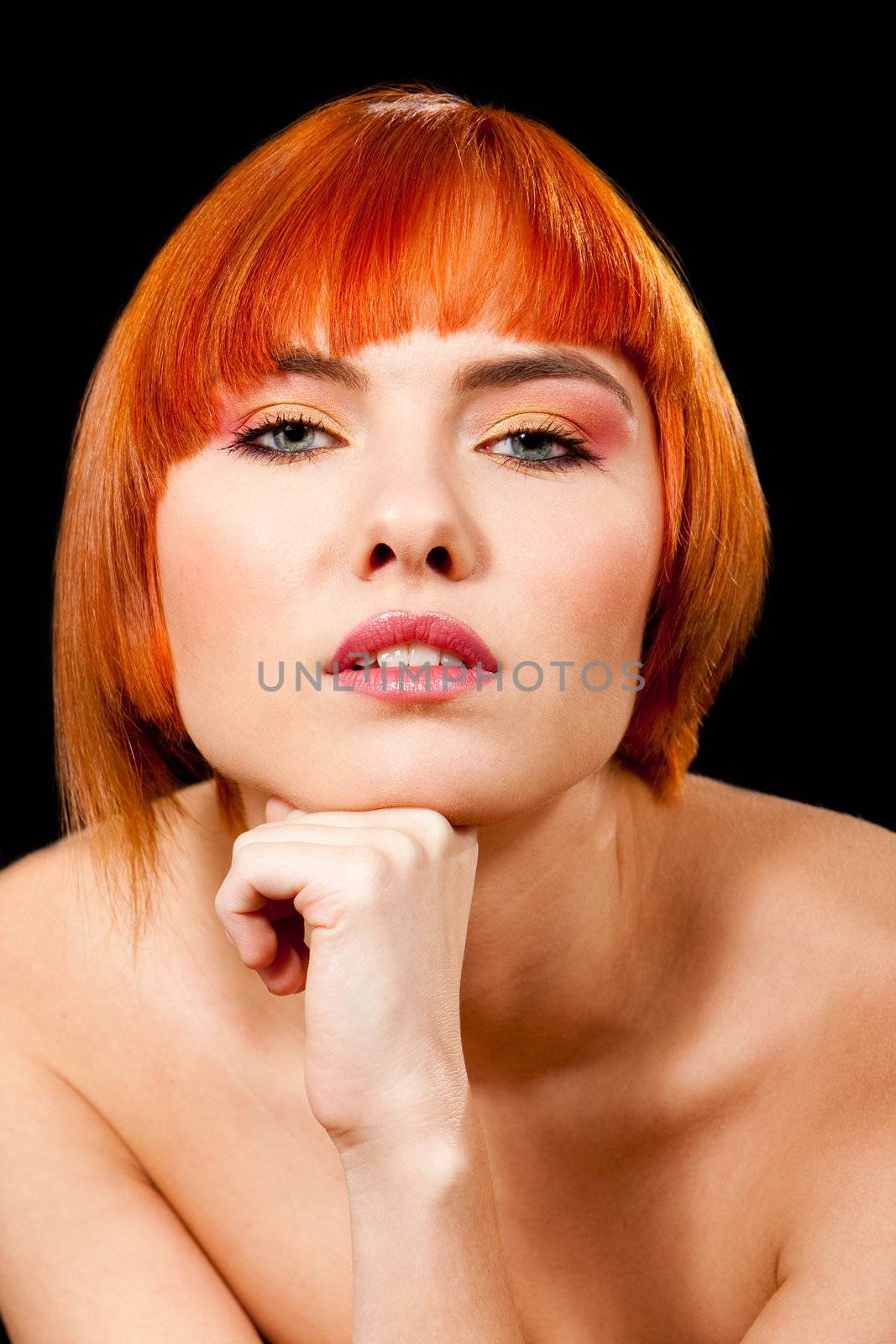 Face of a beautiful Caucasian redhead girl with fist under chin, isolated