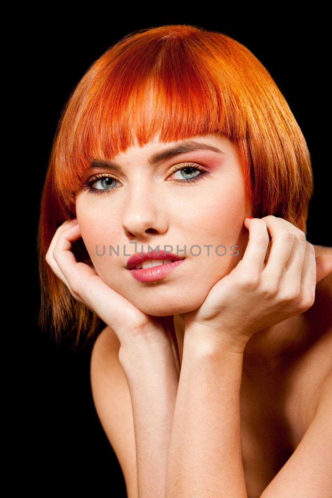 Face of a beautiful Caucasian redhead girl with glossy blue eyes supporting her head with hands, isolated