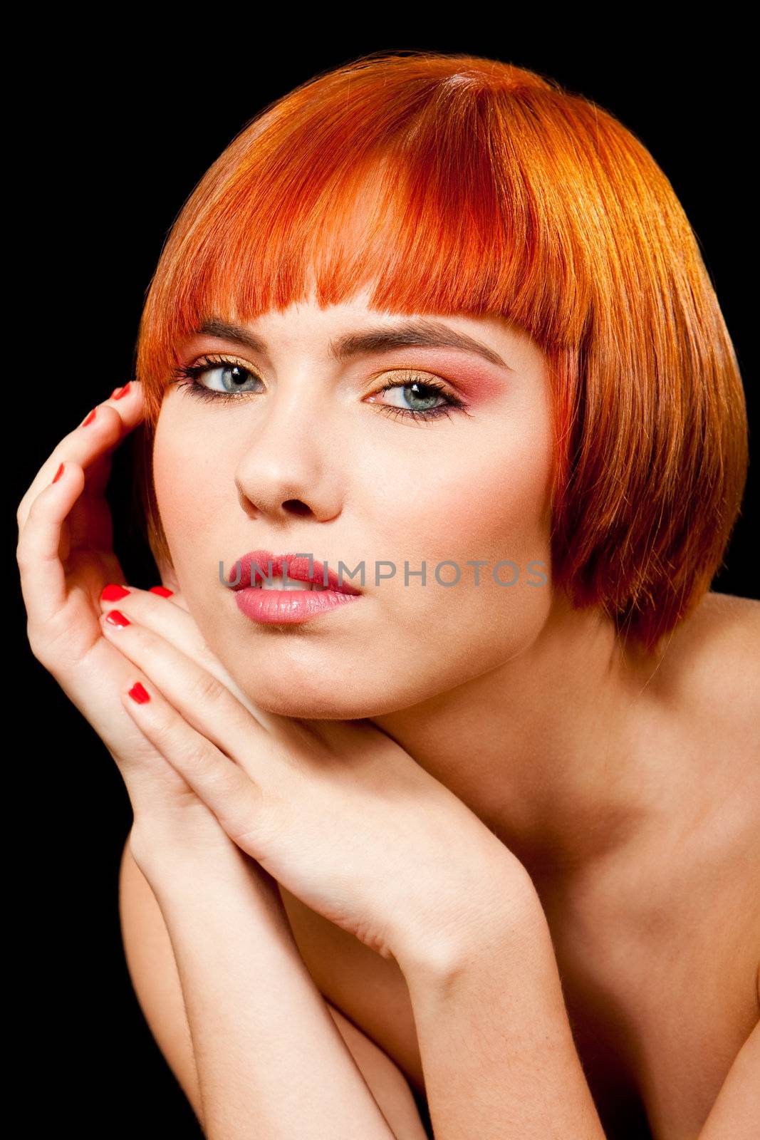 Face of a beautiful Caucasian redhead girl with hands besides head, isolated