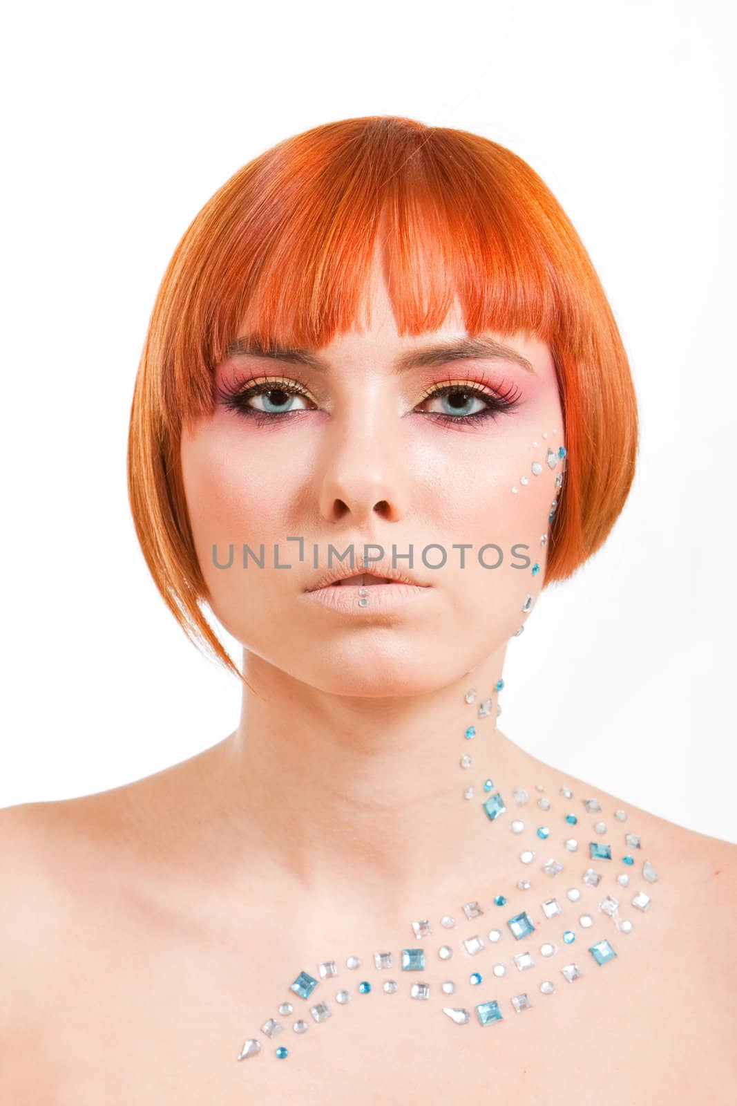 Beautiful face of a redhead Caucasian girl with sea blue eyes and rhinestones, isolated