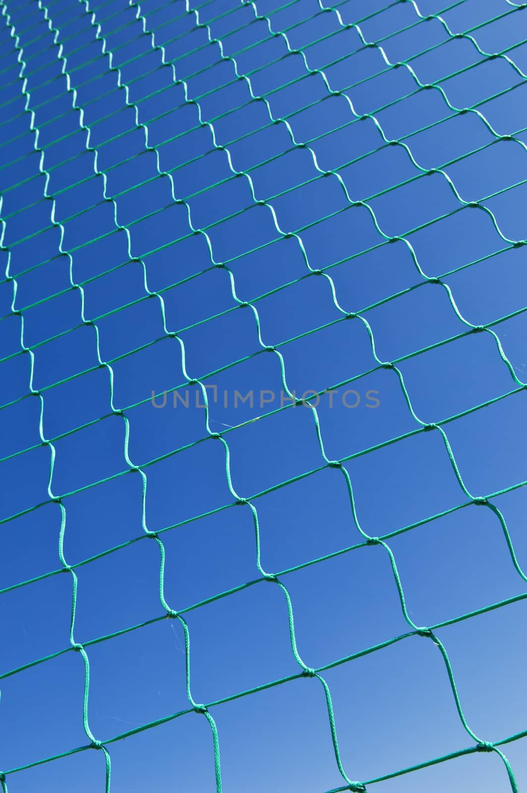 Nylon net pattern detail against a clear blue sky
