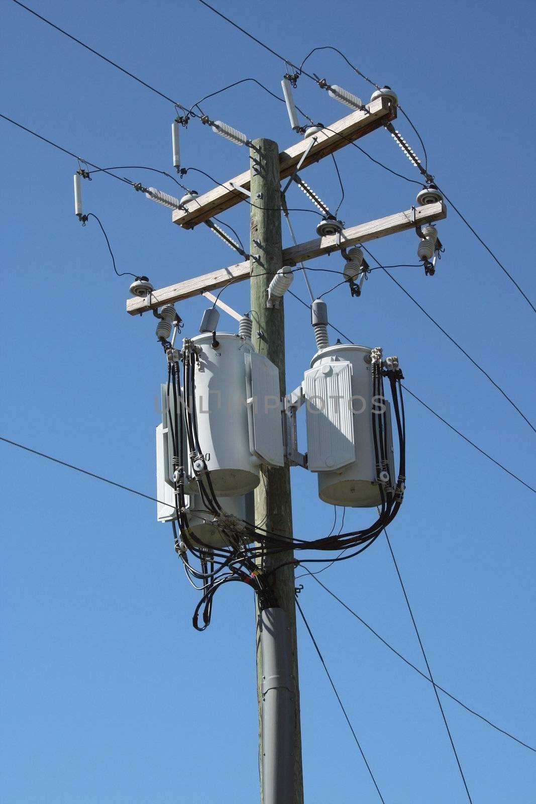 A Telephone pole with three transformers