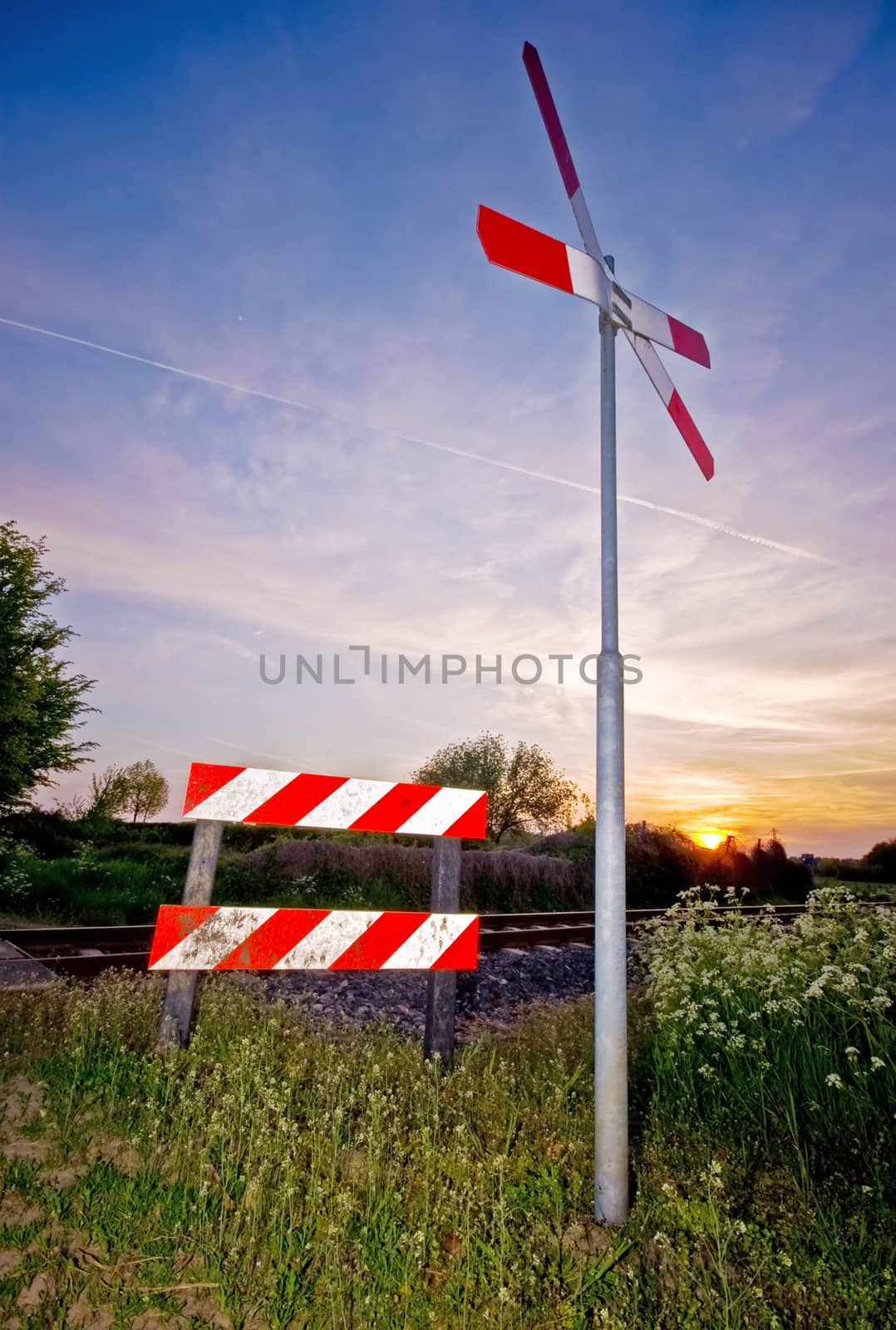 crossing railroad sign with a nice colorful sunset
