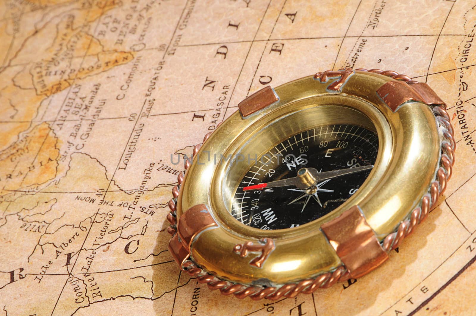 old-fashioned compass on an old map by dyoma