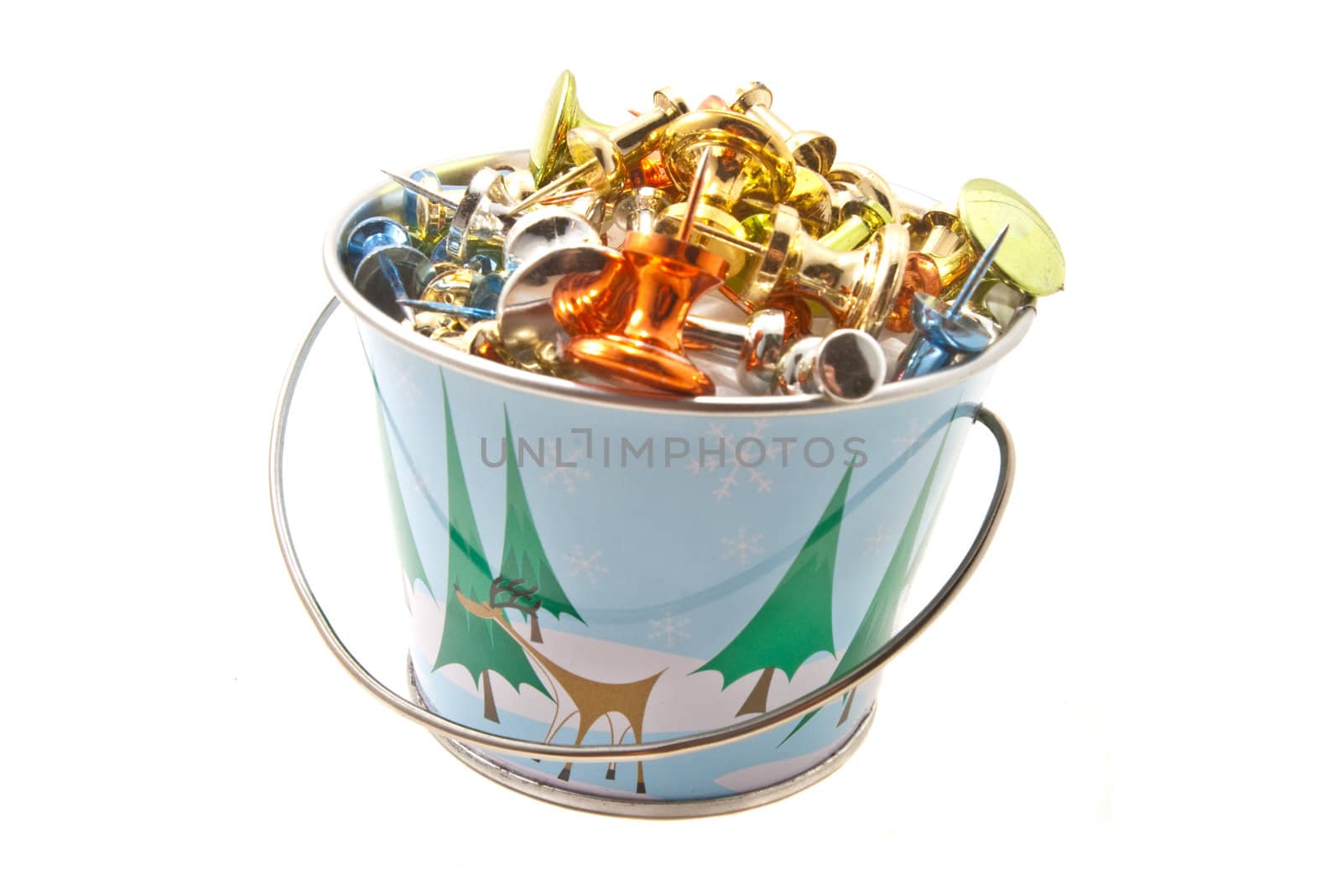 Miniature bucket with Holiday design, filled with brightly colored push pins.  Isolated on a white background.