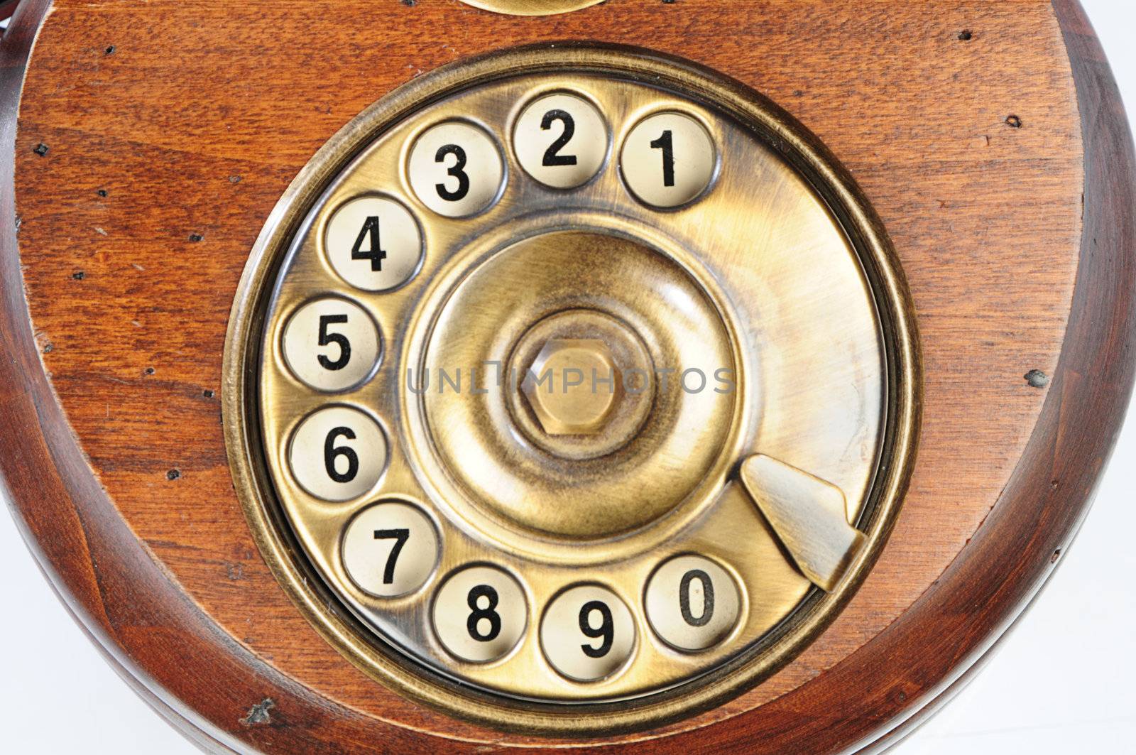 old-fashioned phone dial on wood antique phone