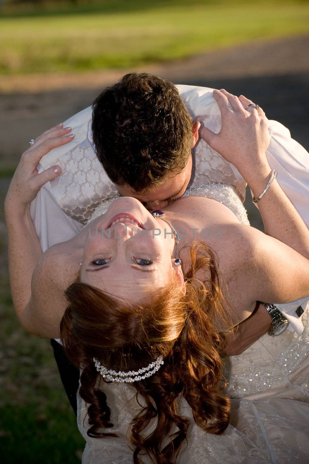 just married couple with groom kissing bride in the cleavage by Ansunette