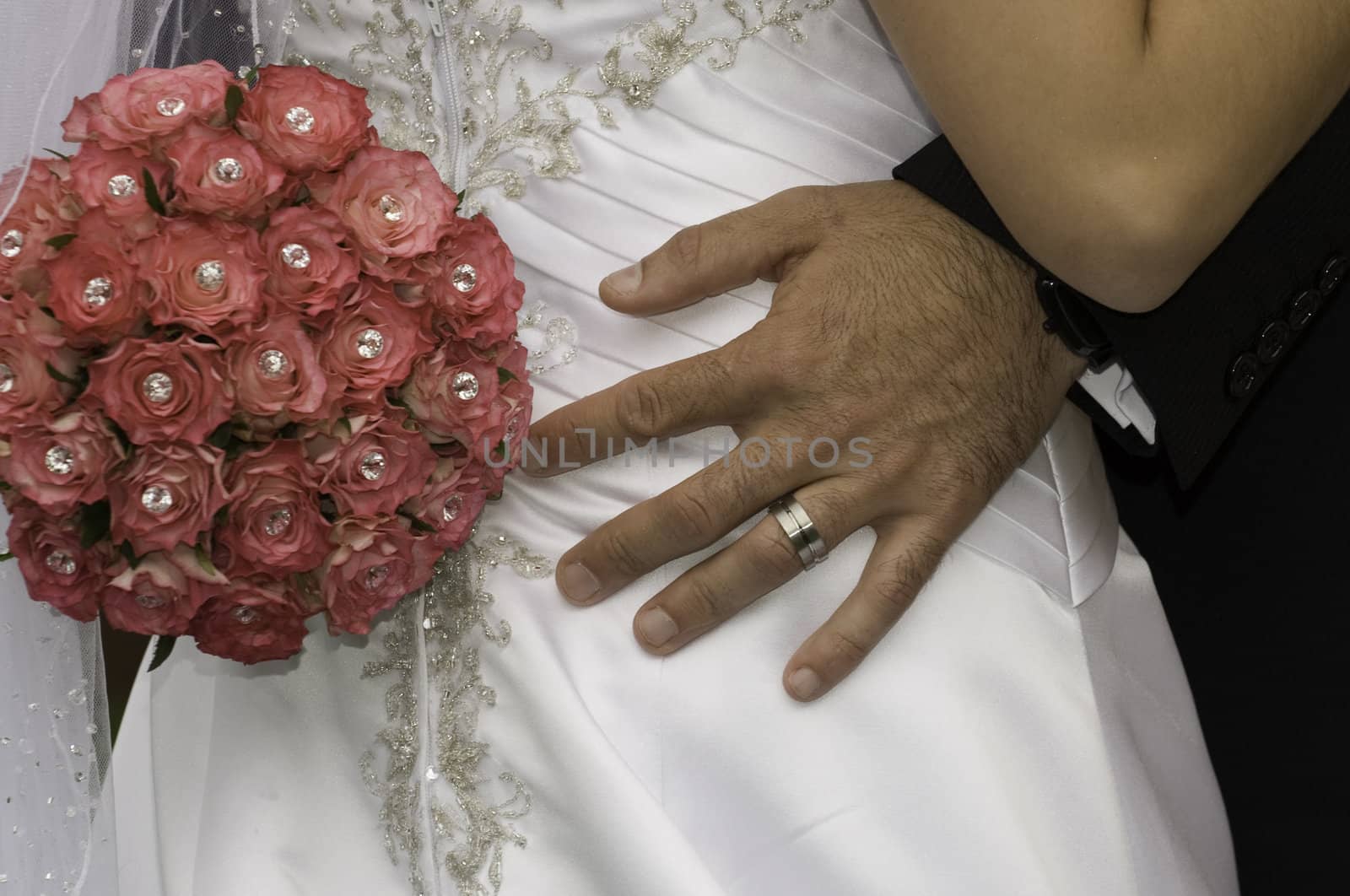 groom standing with his hand red bouquet on his brides bum by Ansunette