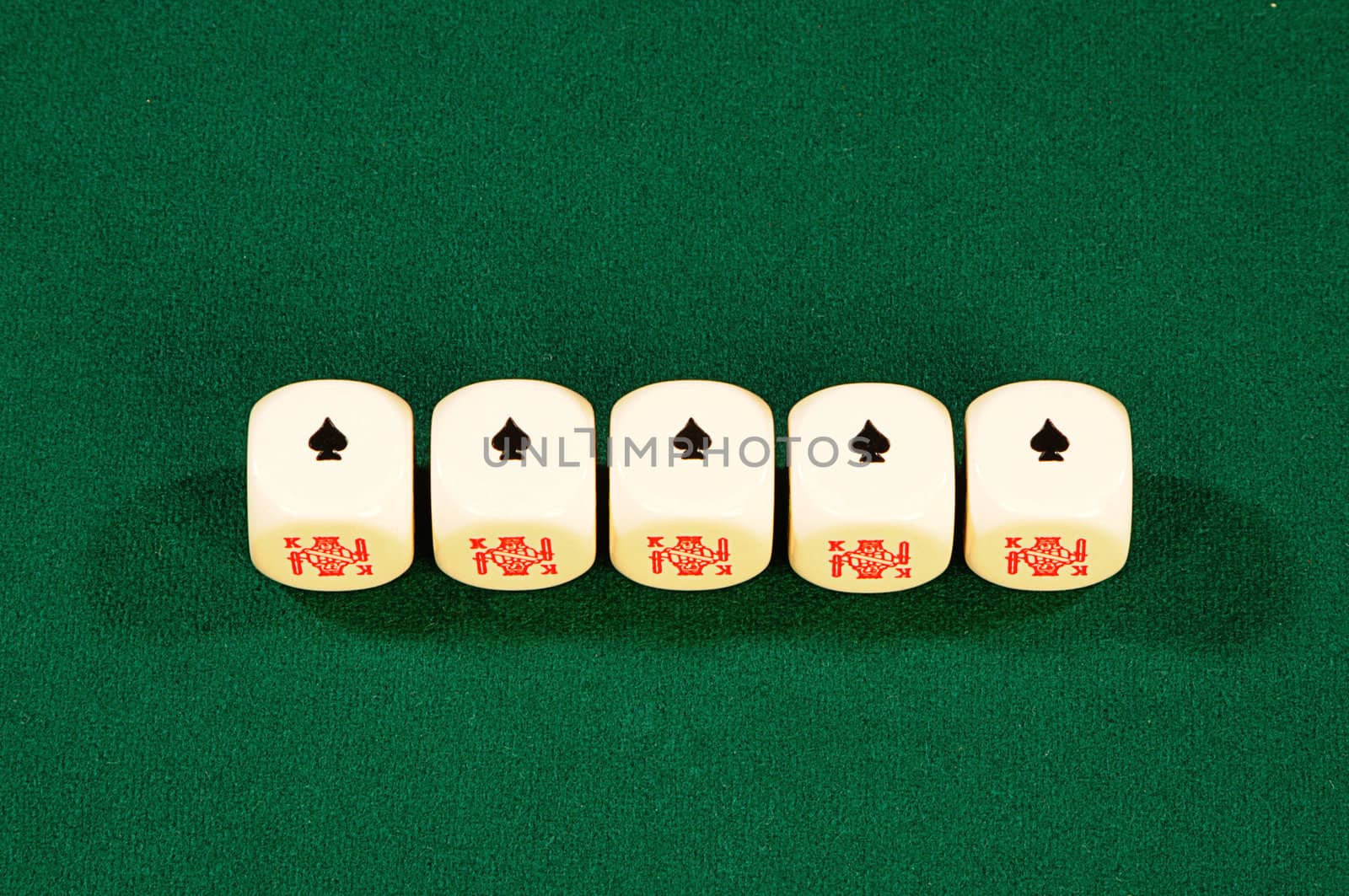 five dice on green felt