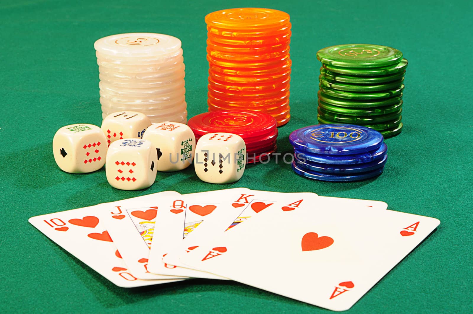 Casino chips,playing bones and royal flash combination on green felt