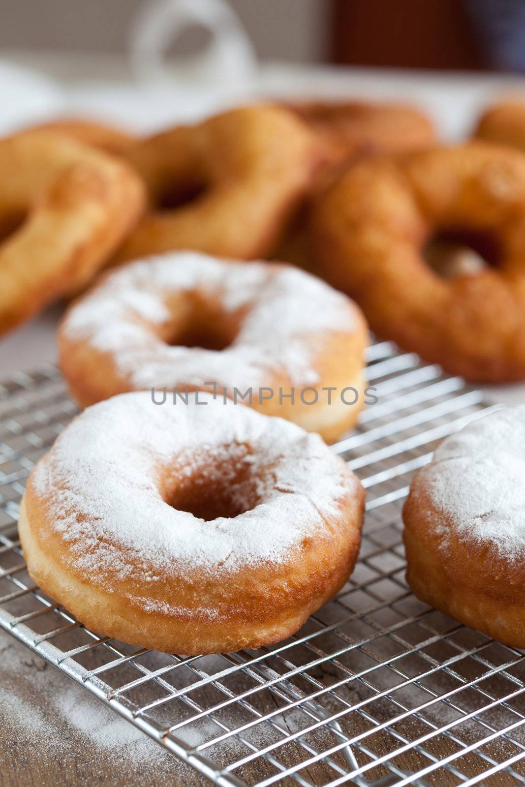 Freshly baked doughnuts sprinkled with icing sugar