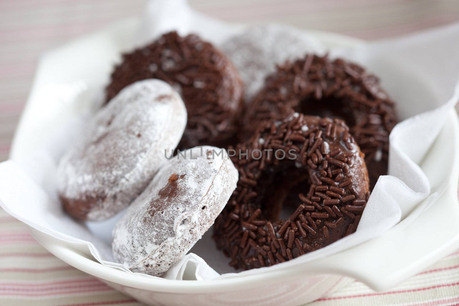 Small bowl with chocolate doughnuts by Fotosmurf