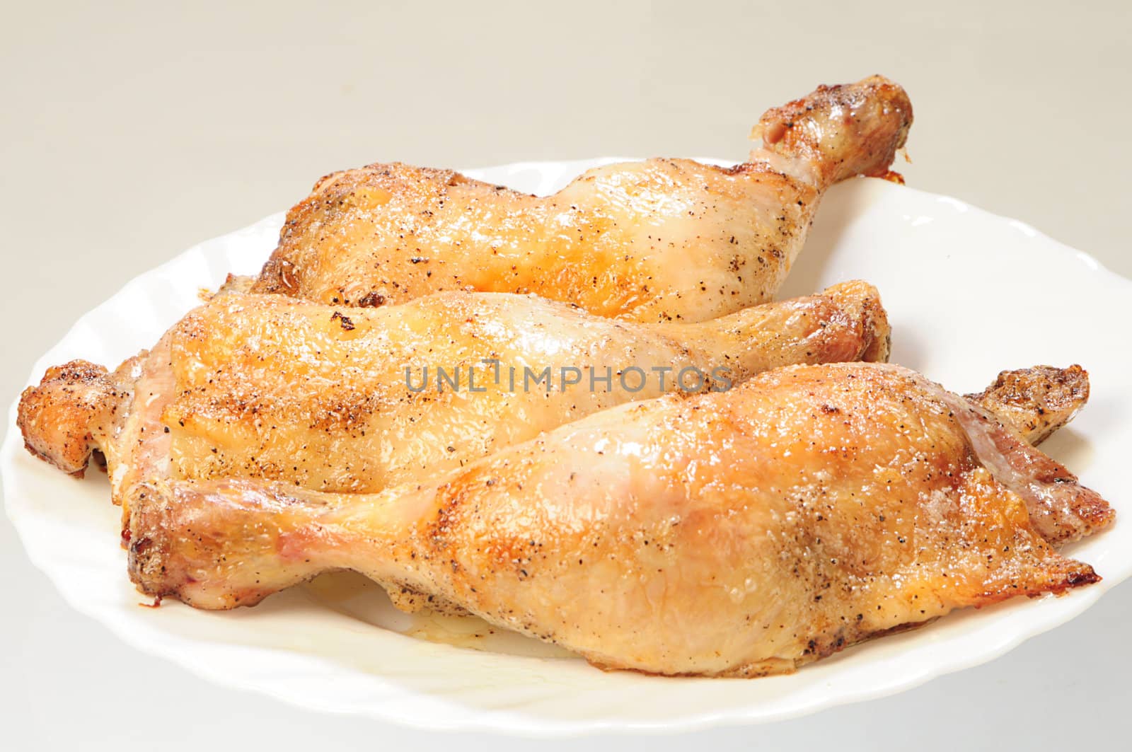 fried chicken legs on white plate by dyoma