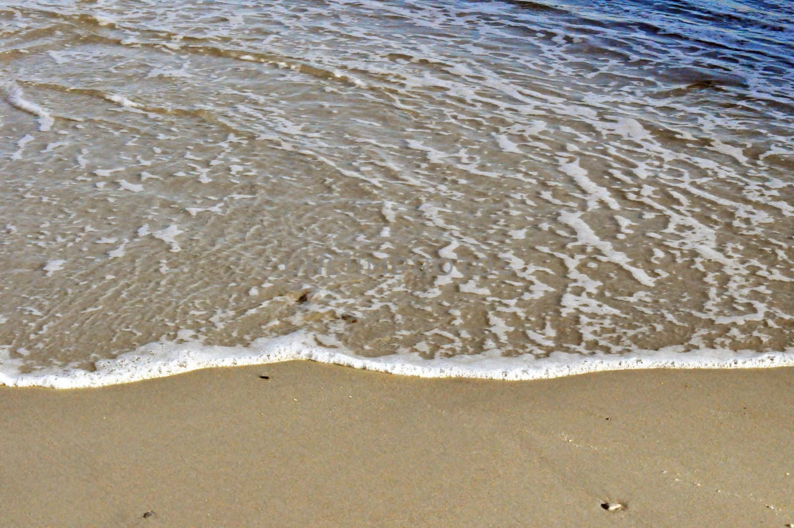 Wave on the sand by RefocusPhoto