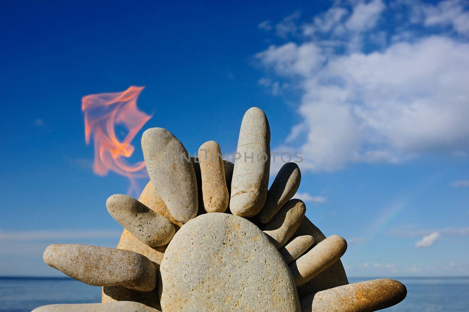 Symbol of the Sun with flames on stone