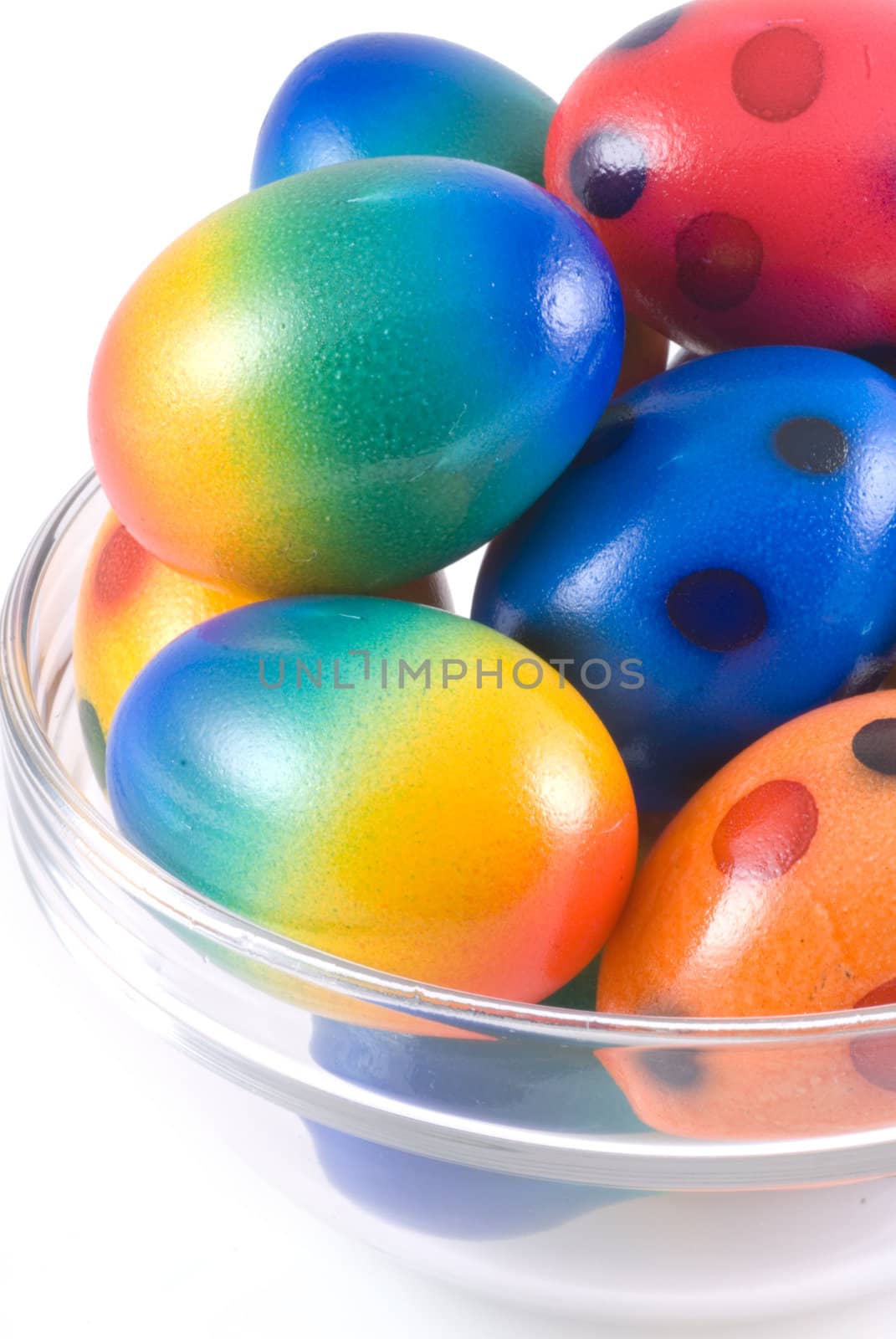 Easter eggs in bowl of glass, isolated on white.