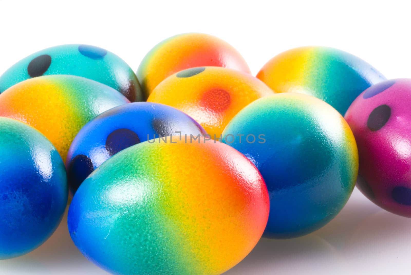 Close up of a bunch of easter eggs on white.