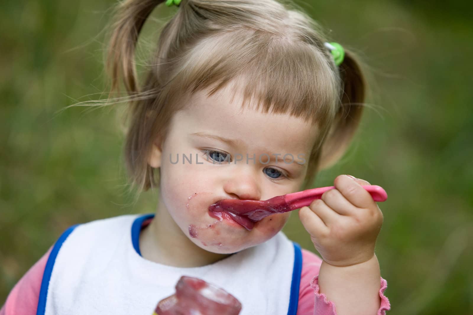 people series: little girl are eating fruit jam