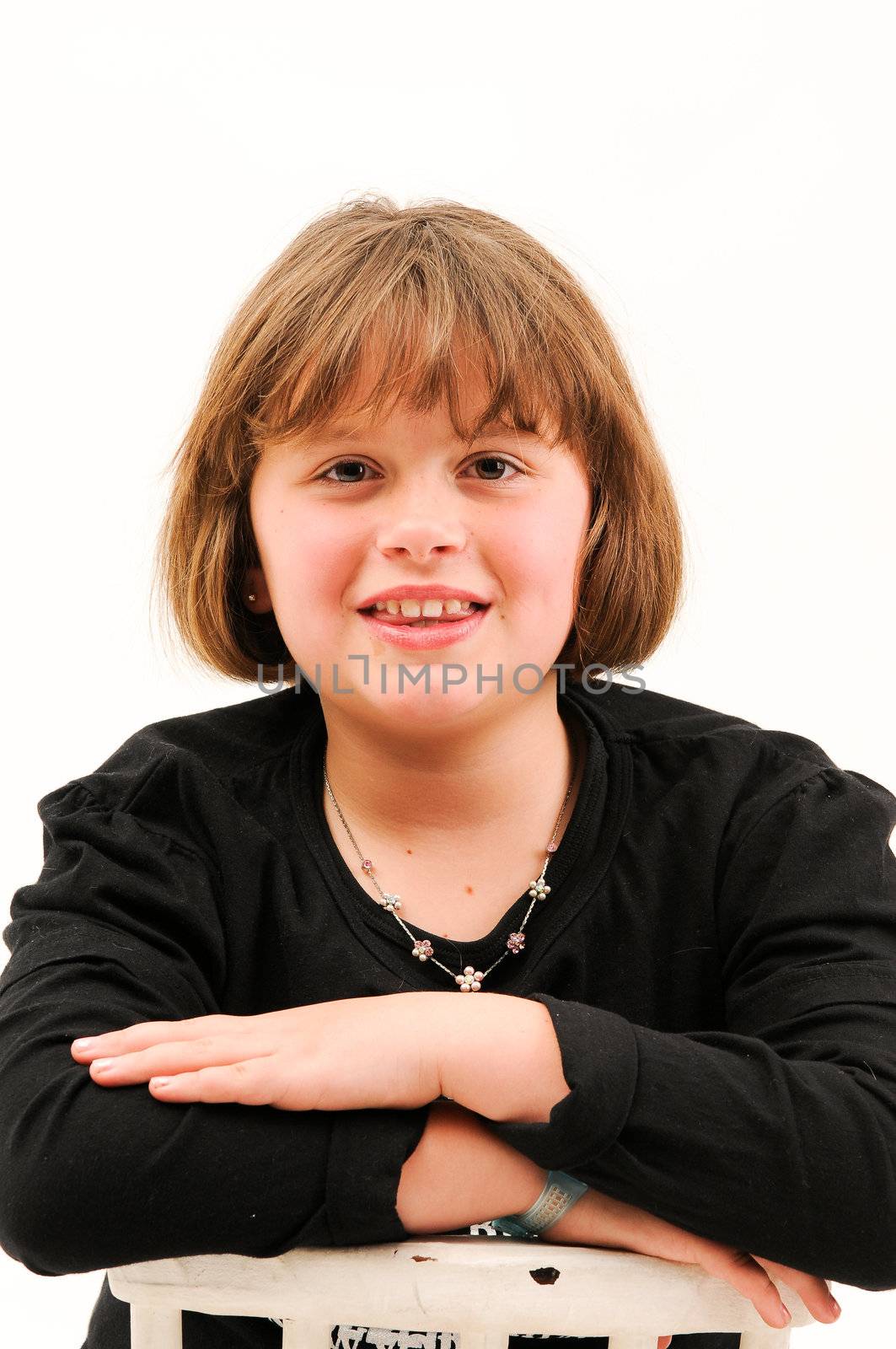 beautiful brown hair teenager smiling with dimple in cheek sitting on chair by Ansunette